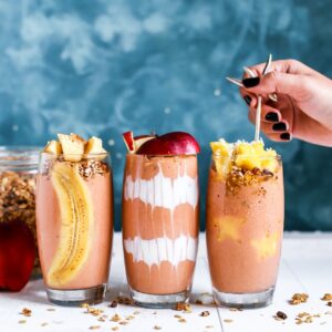 three clear drinking glass filled by shakes