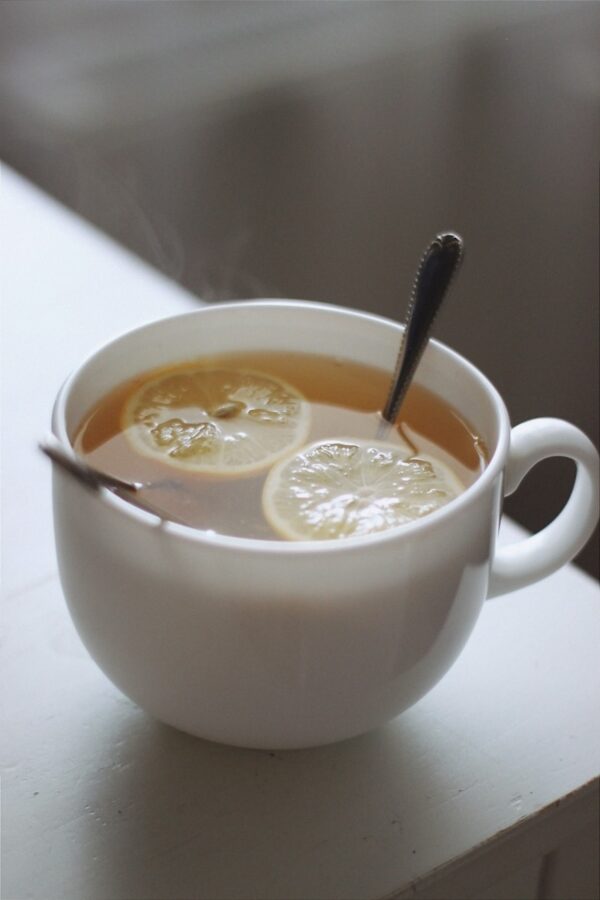 white ceramic mug with yellow liquid