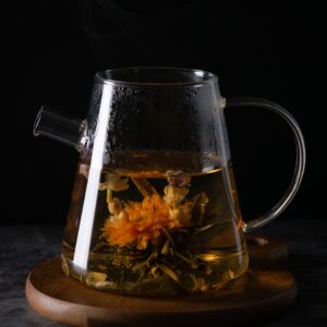 clear glass pitcher with brown liquid inside